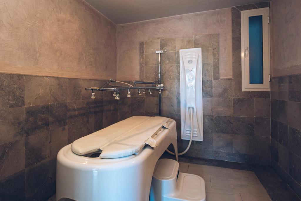 a bathroom with a toilet and a shower at Iberostar Waves Mehari Djerba in Taguermess