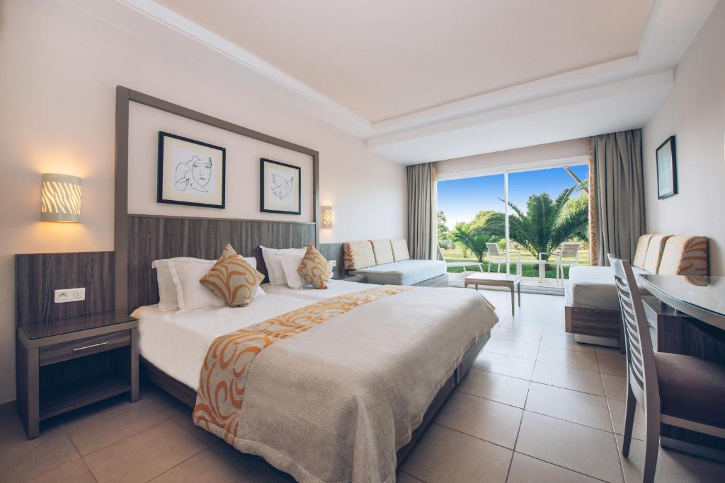 a hotel room with a large bed and a window at Iberostar Waves Mehari Djerba in Taguermess