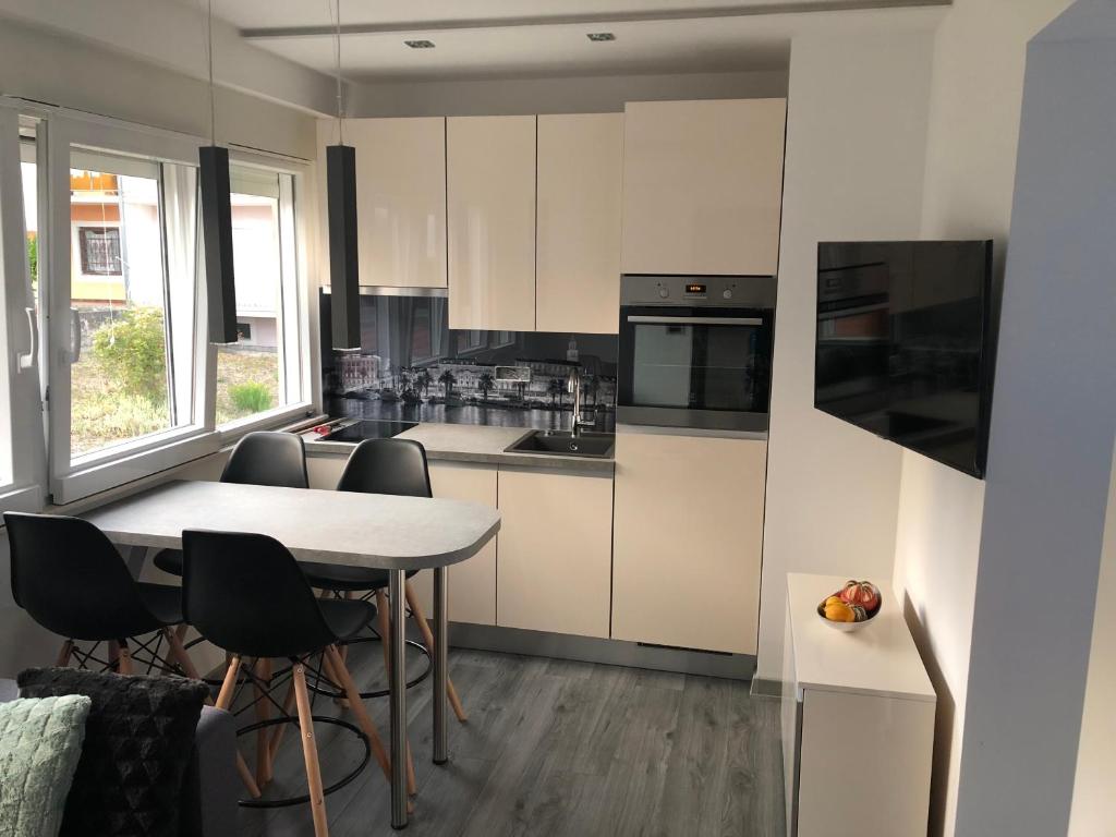 a kitchen with a table and chairs in a room at Dream Apartments in Split