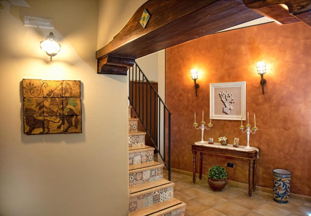 a staircase in a house with a painting on the wall at Bed and Breakfast Conte Luna in Sciacca