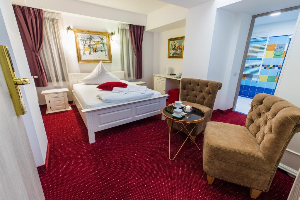 Un pat sau paturi într-o cameră la Hotel Casa David