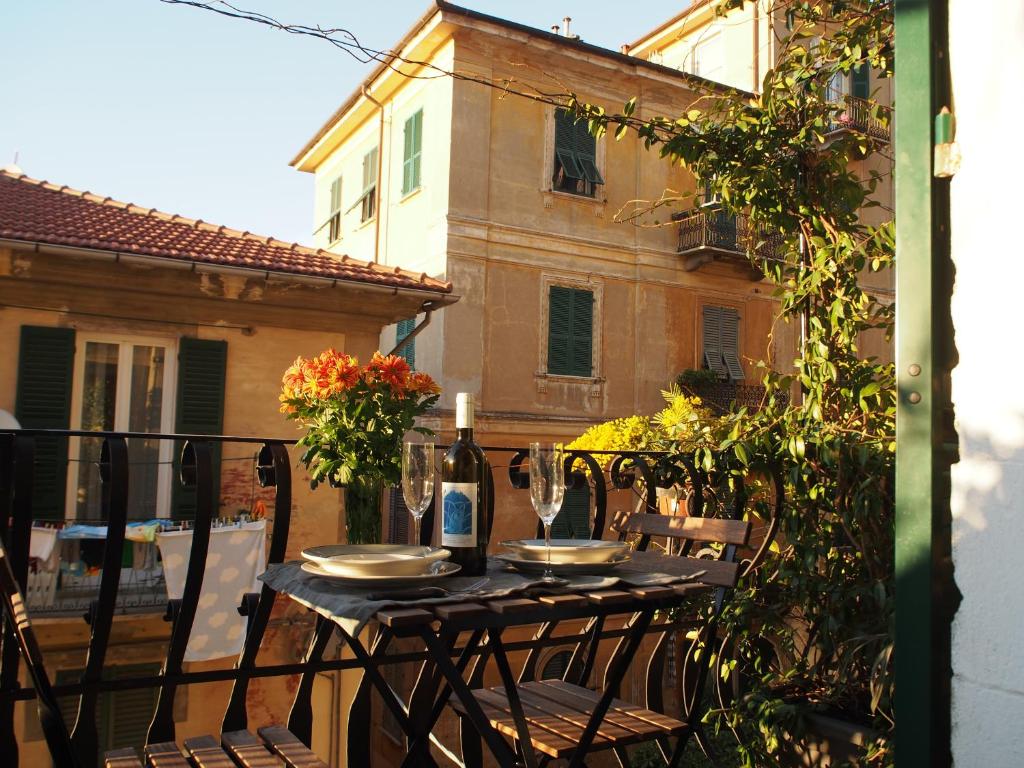 a table with a bottle of wine on a balcony at B&B Cernaia 42 in La Spezia