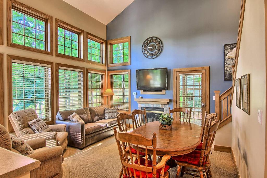 a living room with a wooden table and a couch at 604 Disciples Village Condo in Boyne Falls