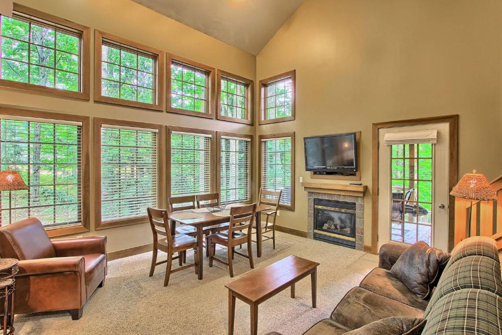 a living room with a couch and a table at 666 Disciples Village Condo in Boyne Falls