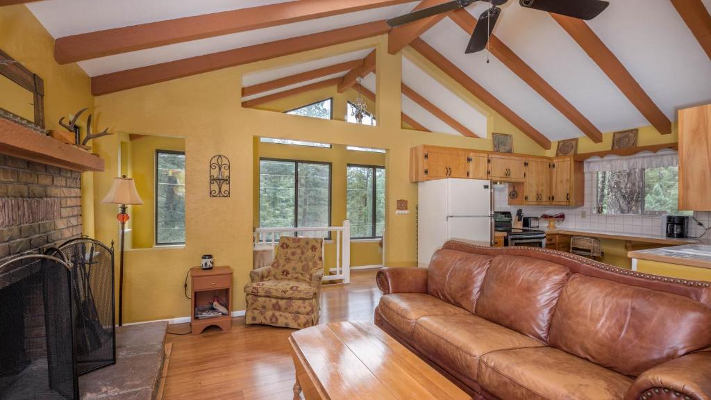 a living room with a couch and a fireplace at Lands End in Ruidoso