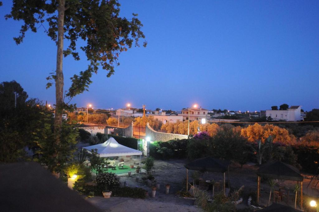 a view of a garden at night at B&B Villa Anna in Marinella di Selinunte