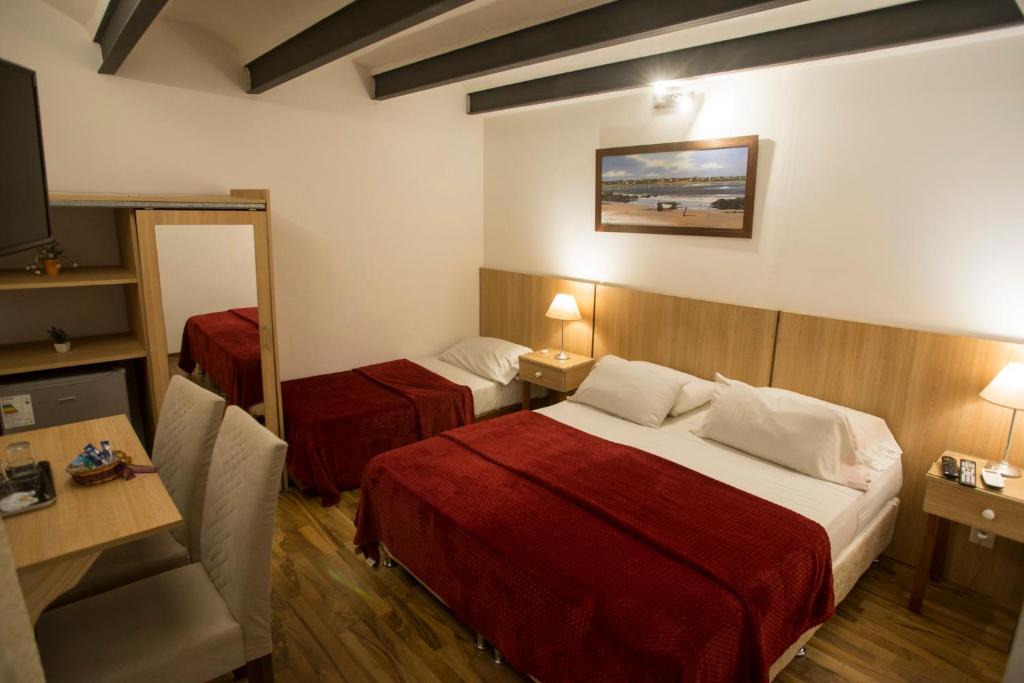 a hotel room with a bed and a mirror at Hotel Casablanca Montevideo in Montevideo