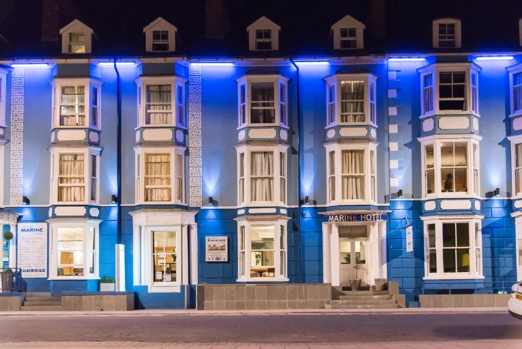 a blue lit up building at night at Marine Apartment in Aberystwyth