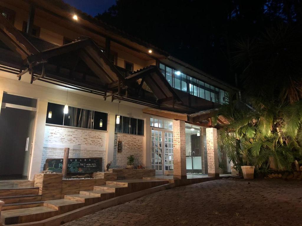 - un bâtiment avec des escaliers devant lui la nuit dans l'établissement Pousada Requinte da Mantiqueira, à Piracaia