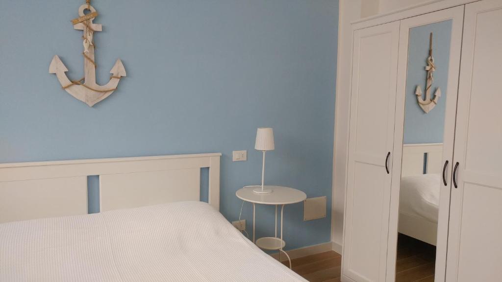 a bedroom with a white bed and a table at Senigallia d'aMare in Senigallia