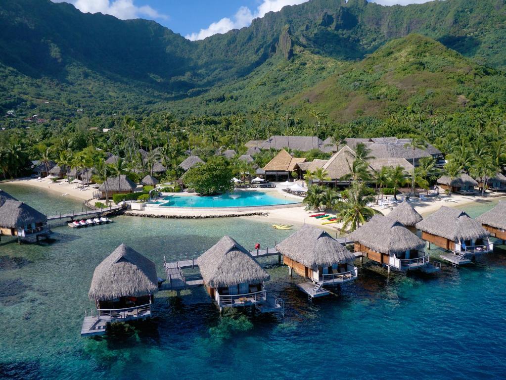 a beach scene with a large body of water at Manava Beach Resort & Spa Moorea in Maharepa