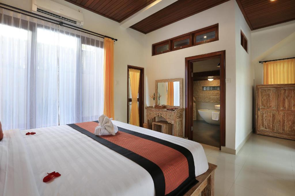 Postel nebo postele na pokoji v ubytování Ketut's Place Cottage Ubud