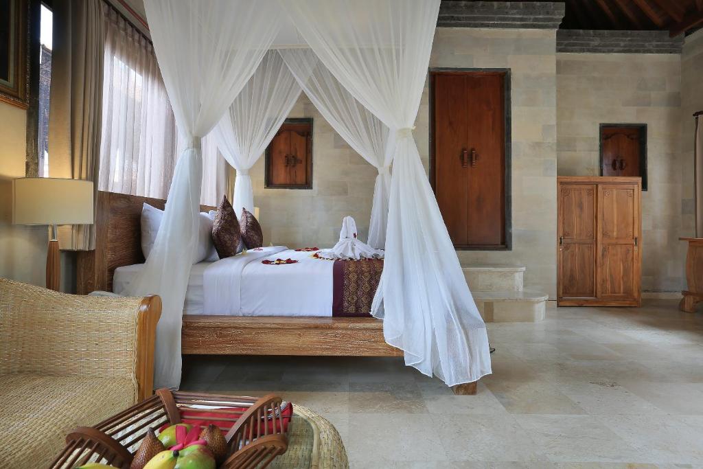 Postel nebo postele na pokoji v ubytování Ketut's Place Cottage Ubud