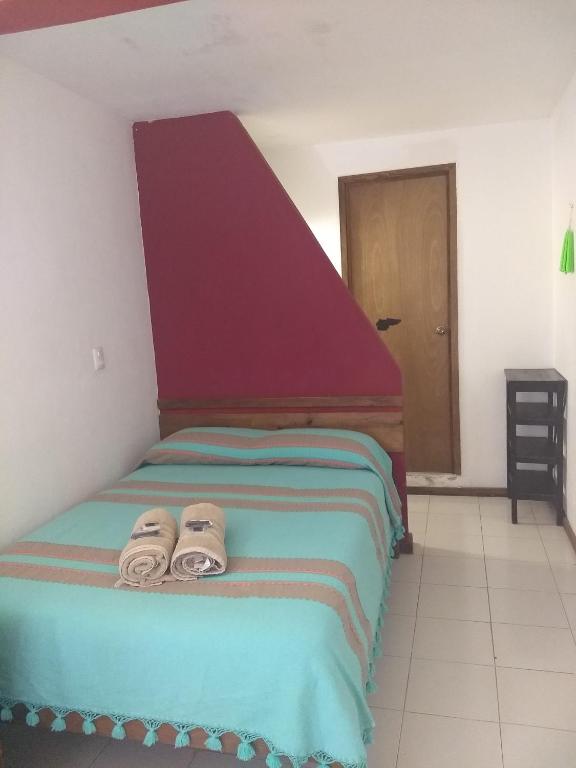 Postel nebo postele na pokoji v ubytování La Abuelita Hostal