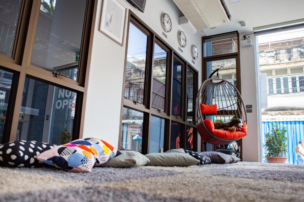 a group of people laying on the floor in a room at Rich8 Hostel in Bangkok