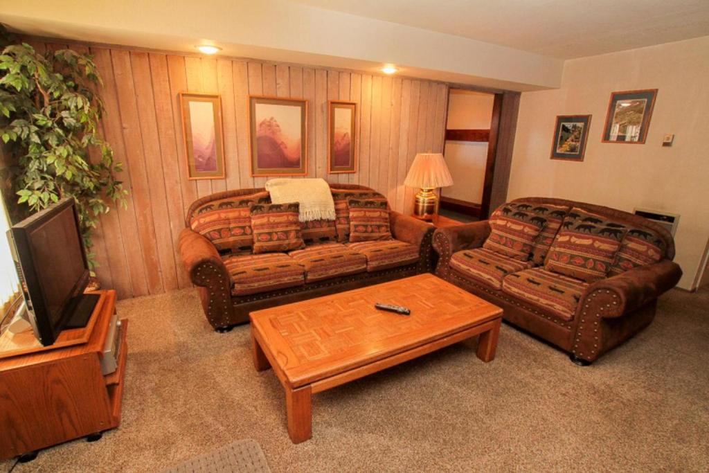 a living room with two couches and a tv at Discovery 4 #125 in Mammoth Lakes