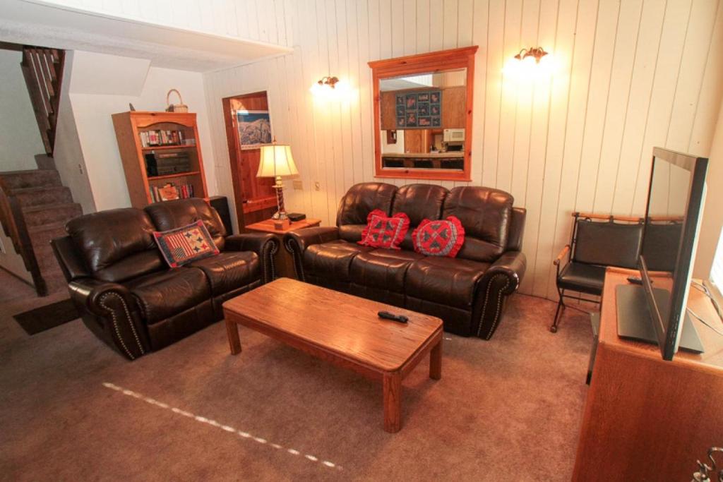 a living room with leather couches and a coffee table at Discovery 4 #128, Loft in Mammoth Lakes