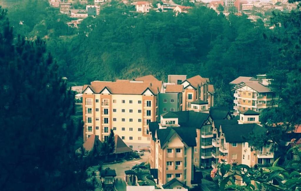a large group of buildings in a city at Courtyards Peak-Corner Pinestay - at Goshenland Baguio in Baguio
