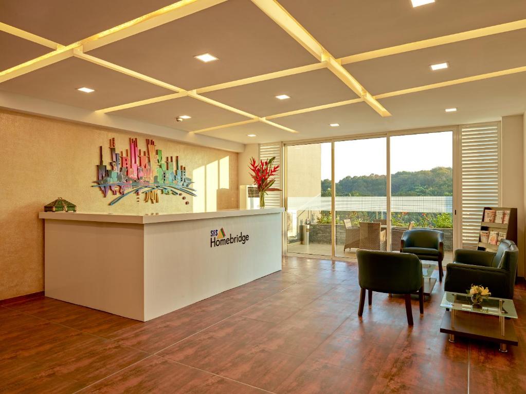 an office lobby with a reception desk and chairs at SFS Homebridge @ Techno Park in Veli
