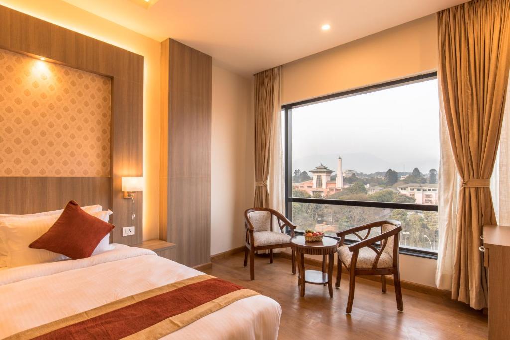 Postel nebo postele na pokoji v ubytování Landmark Kathmandu