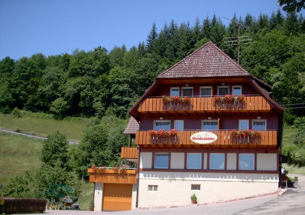 a building with flowers on the balcony of it at Landhaus Waldeshöhe in Baiersbronn