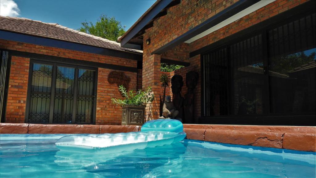 a swimming pool with an inflatable at Ubuntu Bed and Breakfast in Marloth Park