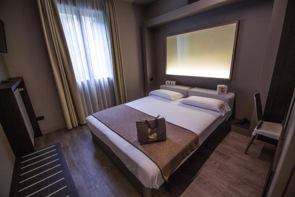 Postel nebo postele na pokoji v ubytování Hotel Bigio