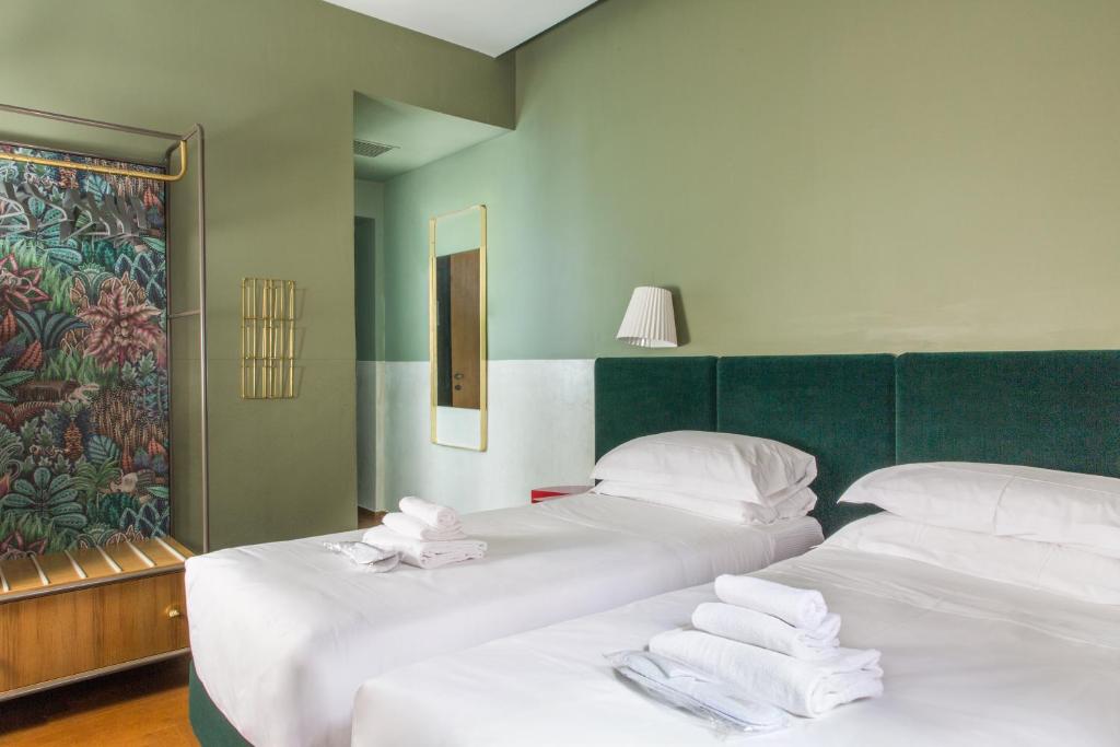 A bed or beds in a room at Condominio Monti Boutique Hotel