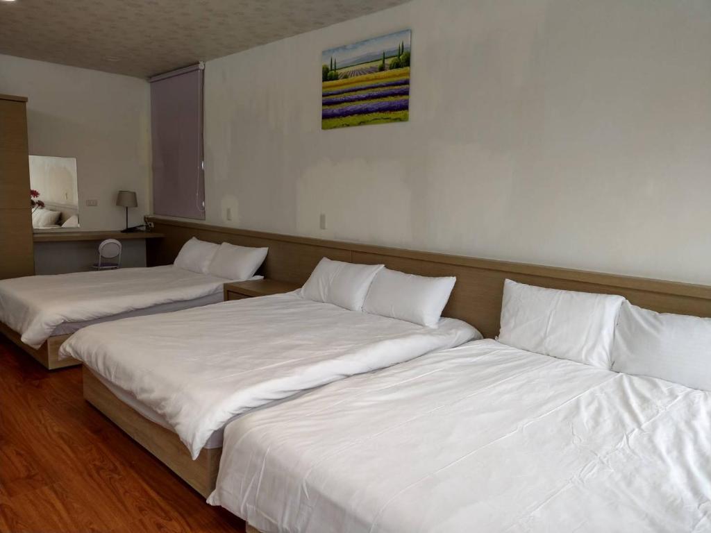 Postel nebo postele na pokoji v ubytování Malin 100 B&B Jiaoxi