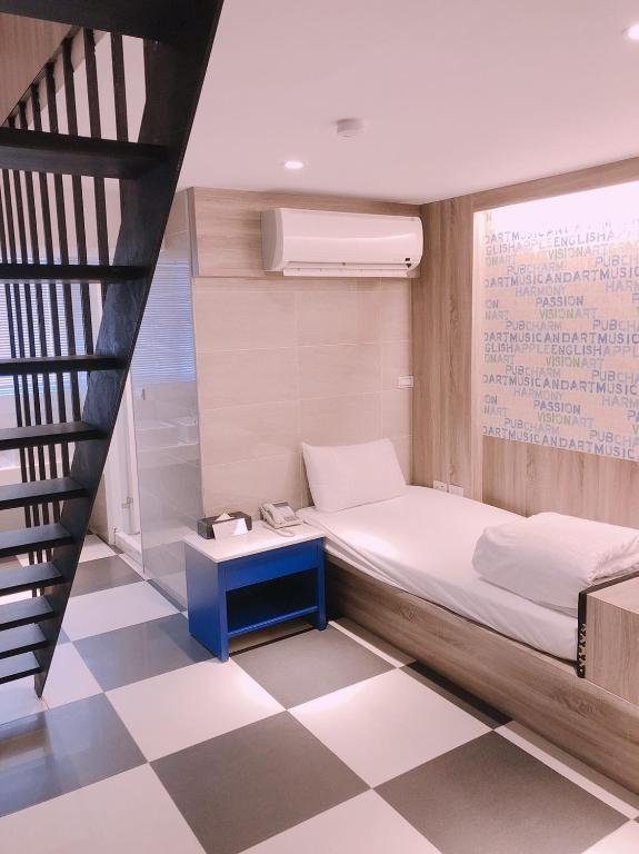 Postel nebo postele na pokoji v ubytování P&E Hotel