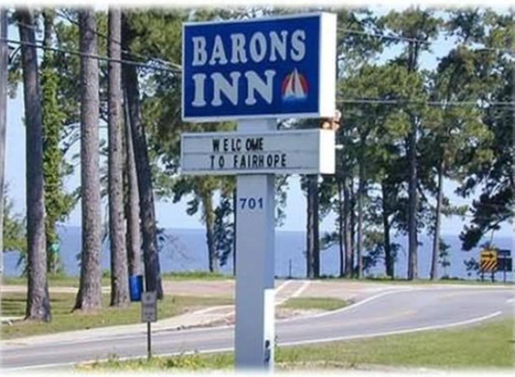 a sign for a barons inn on the side of a road at Magnolia Beach Inn - Fairhope in Fairhope