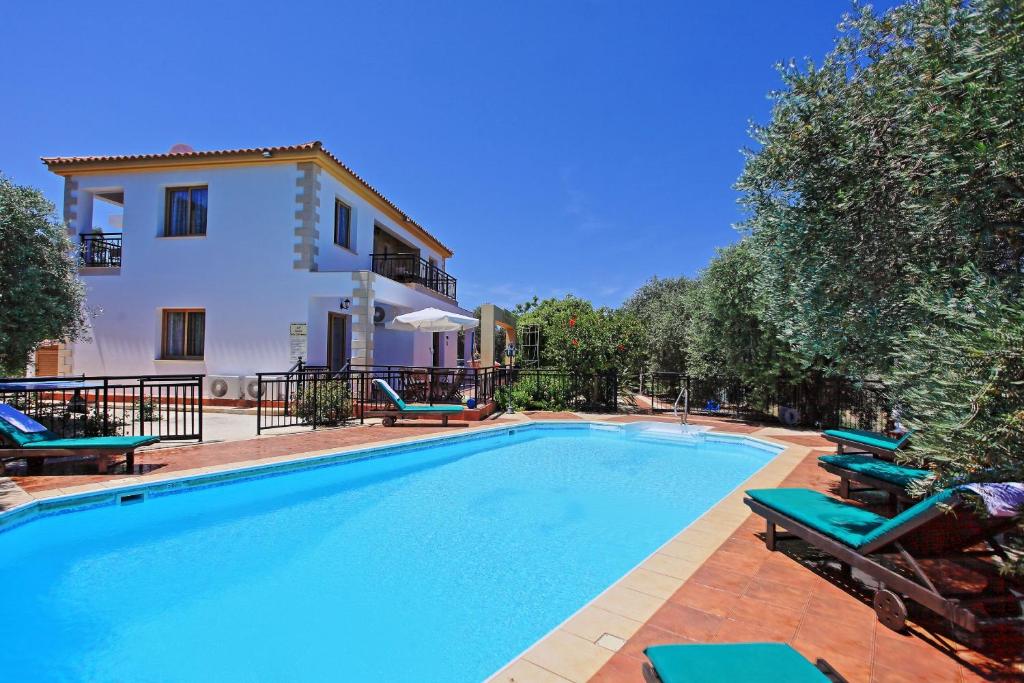a swimming pool in front of a villa at Marilena Sunset Villa 1 in Pomos