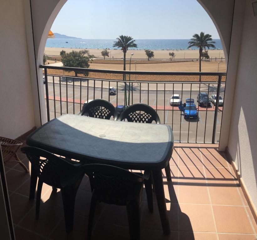 a table on a balcony with a view of the beach at AwayDays - BI - 41 in Empuriabrava