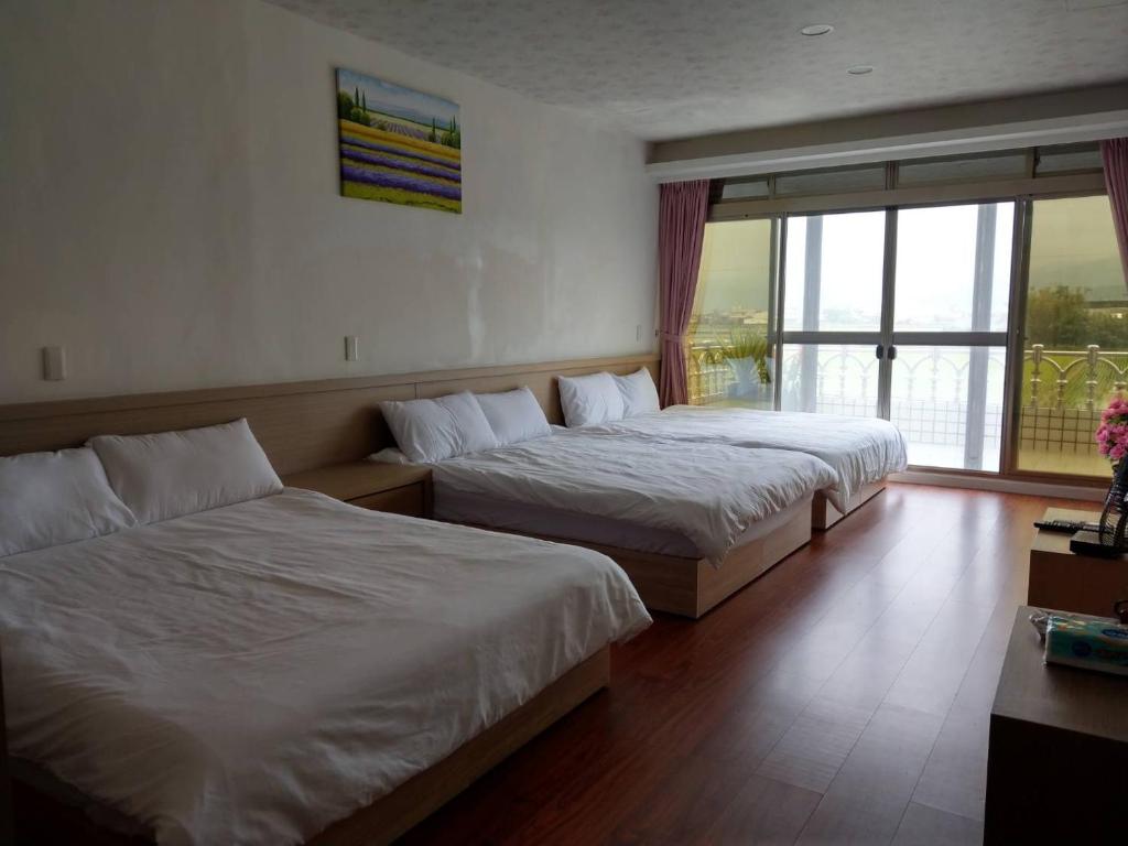Postel nebo postele na pokoji v ubytování Malin 100 B&B Jiaoxi