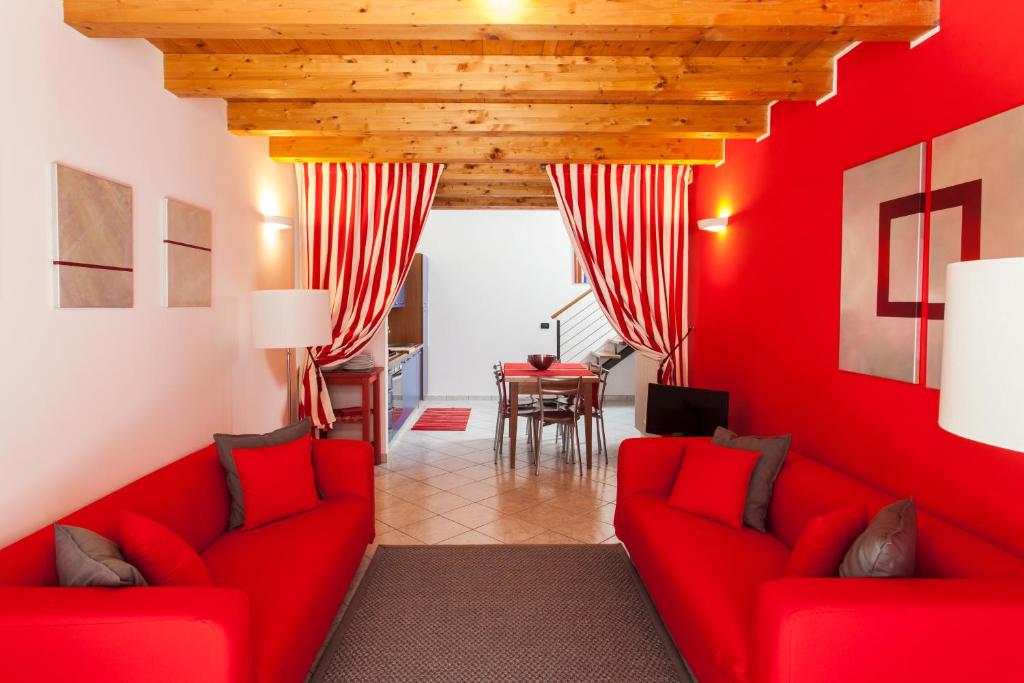 a red living room with two red couches and a table at Stella Marina 3 in Venice