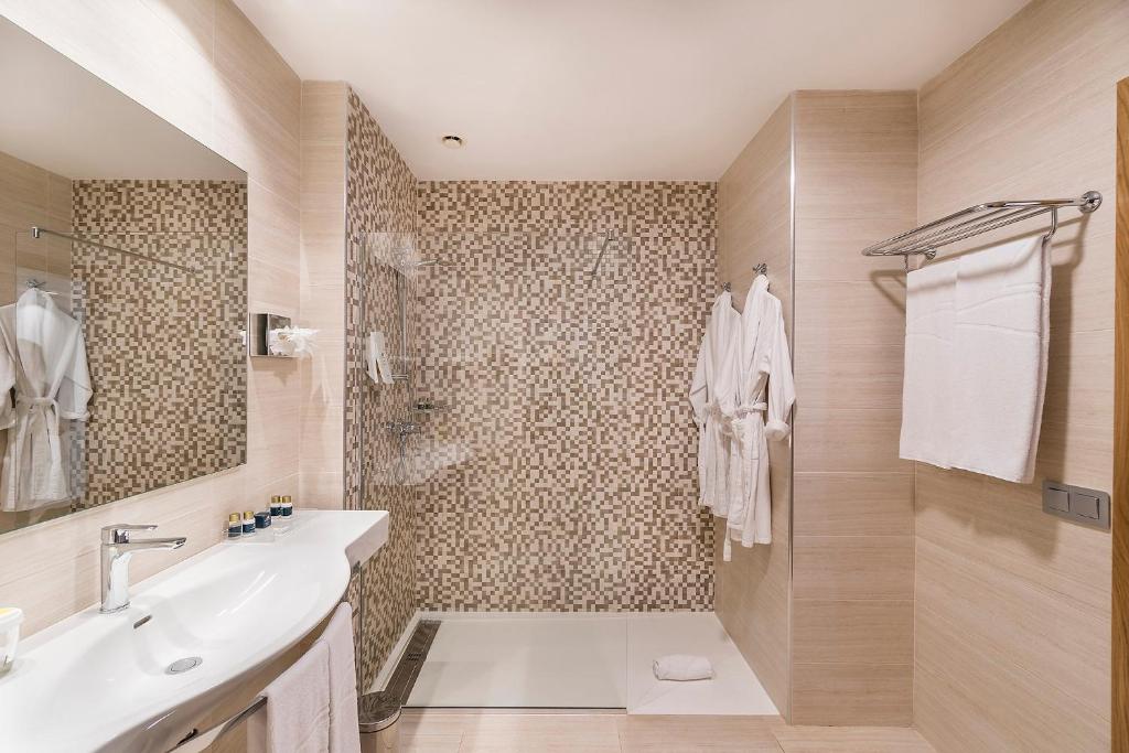 a bathroom with a sink and a shower at Royal Palm Resort & Spa - Adults Only in Playa Jandia