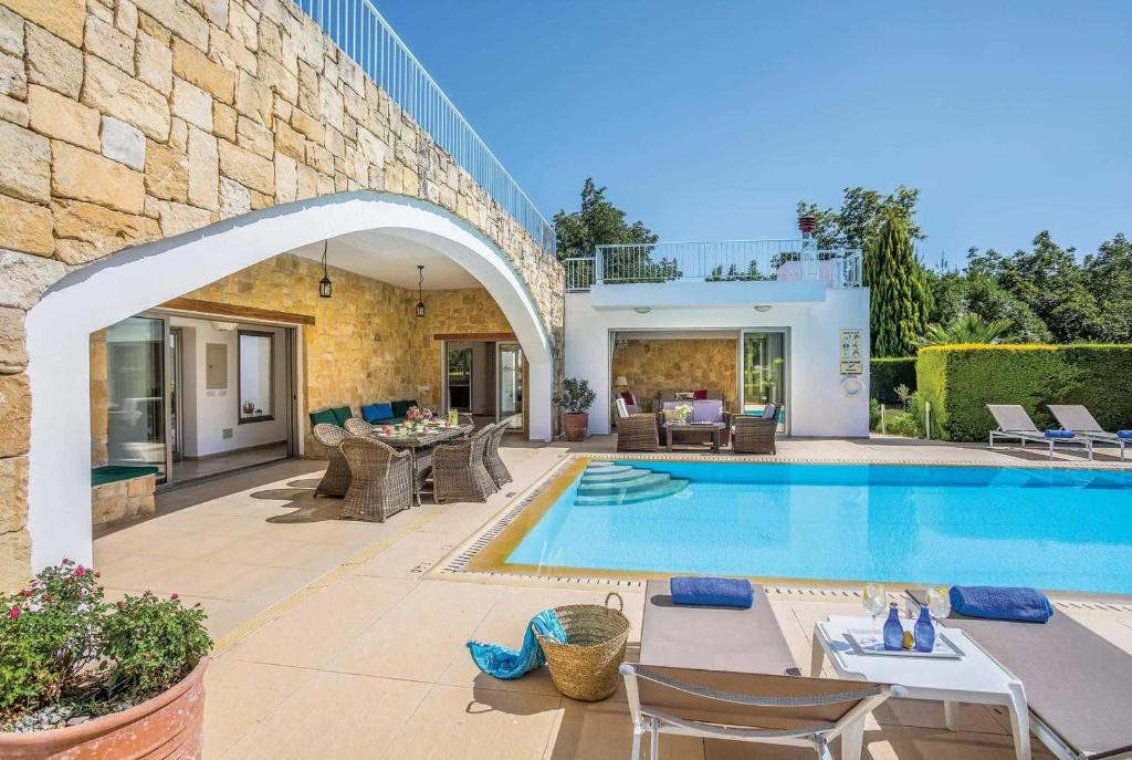 a villa with a swimming pool and a patio at Villa Stephanos in Miliou