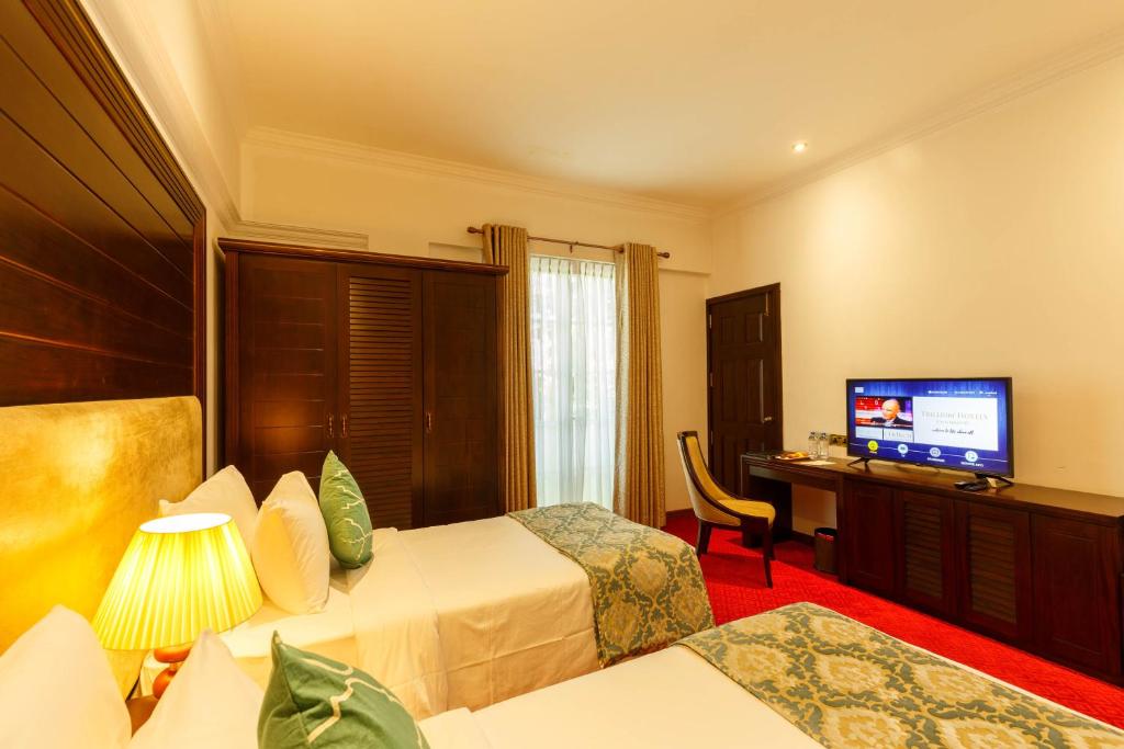 Postel nebo postele na pokoji v ubytování Trillium Boutique City Hotel