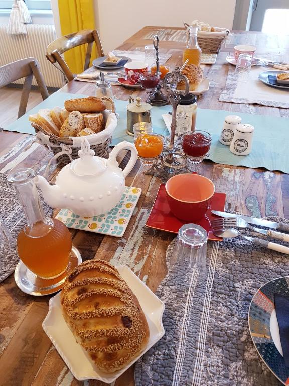 a table with a breakfast of tea and bread at La Maison Bizienne Guérande in Guérande