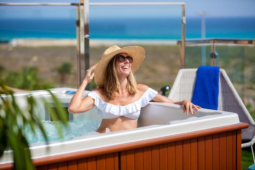 a woman in a bath tub on a boat at MUR Faro Jandia Fuerteventura & Spa in Morro del Jable