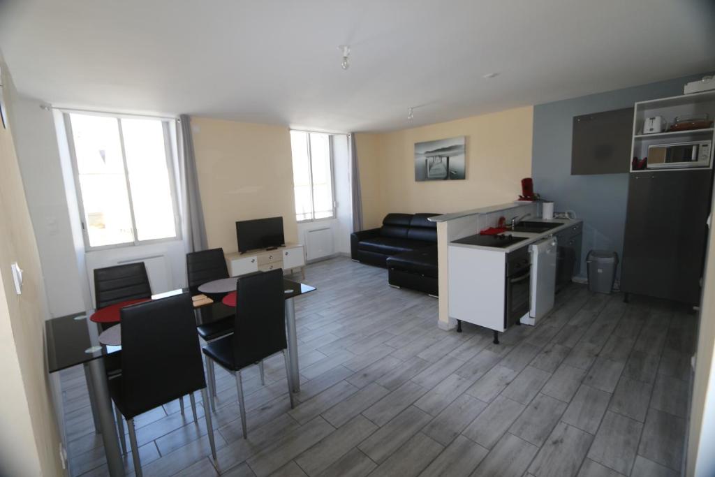 a living room with a couch and a table at Apparts Gites Cholet centre in Cholet