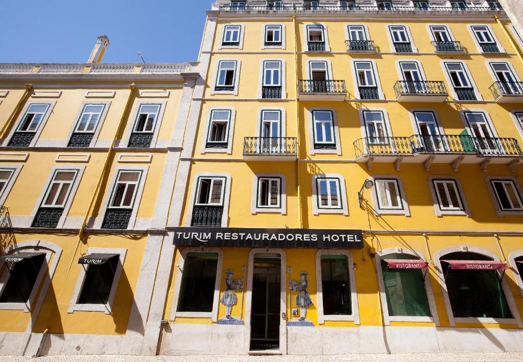 a large building with a clock on the front of it at TURIM Restauradores Hotel in Lisbon
