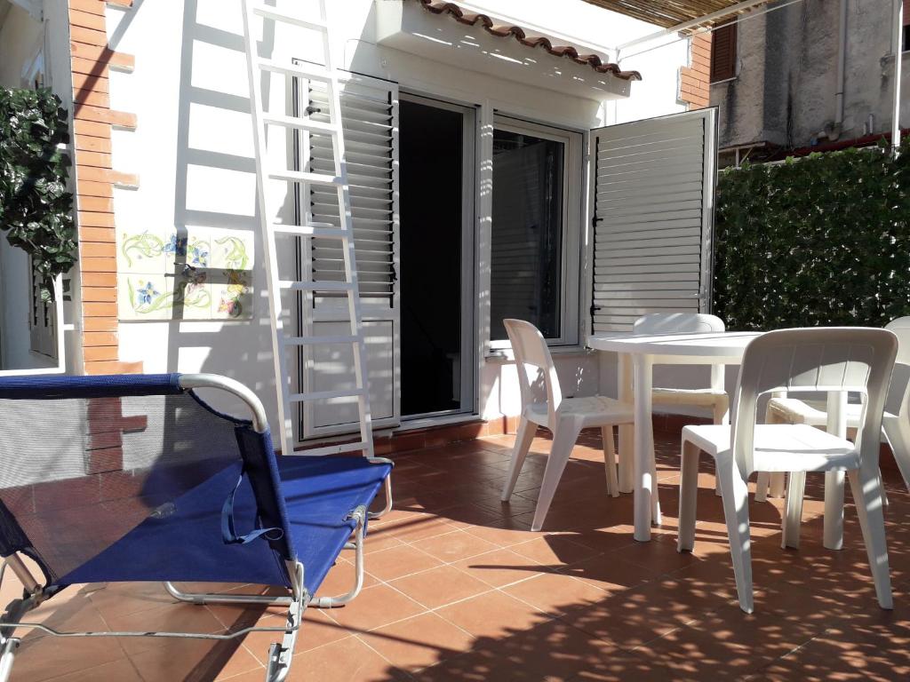 a patio with a white table and chairs on a balcony at Casa BabbaLuciana in Mondello