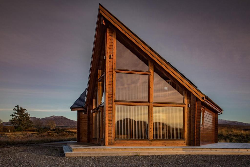 a house with a large window on the side of it at Lorien Lodge in Breakish