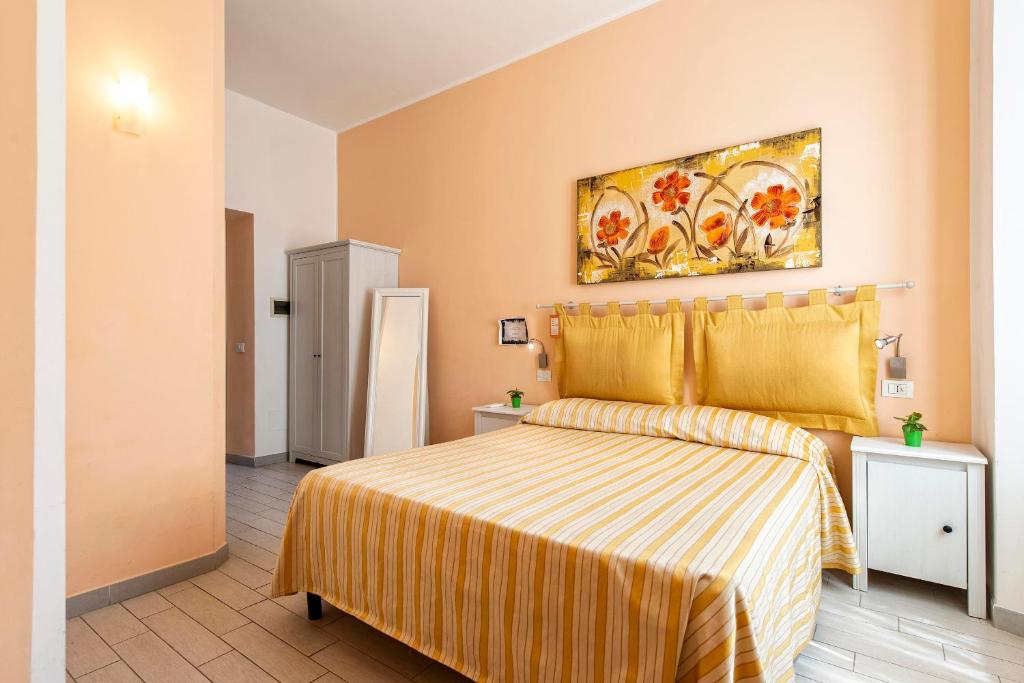 A bed or beds in a room at Merulana Suite 2