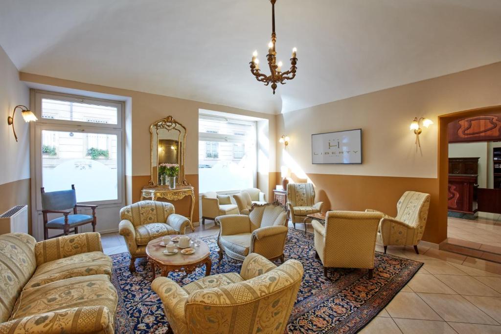 a living room with couches and chairs at Liberty Hotel in Turin