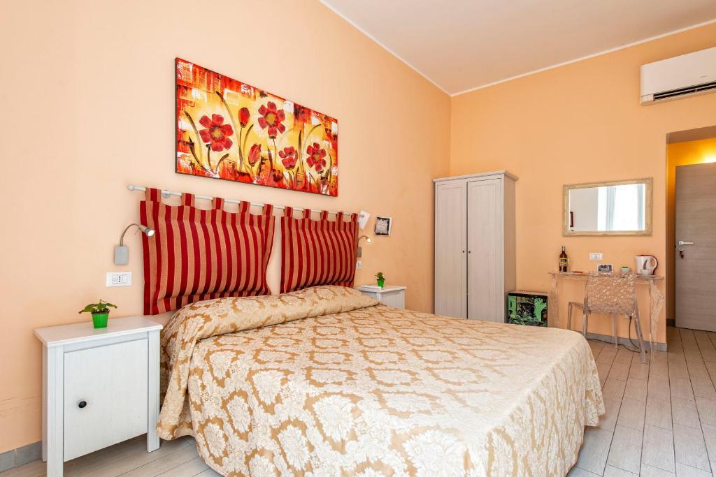 A bed or beds in a room at Merulana Suite 2