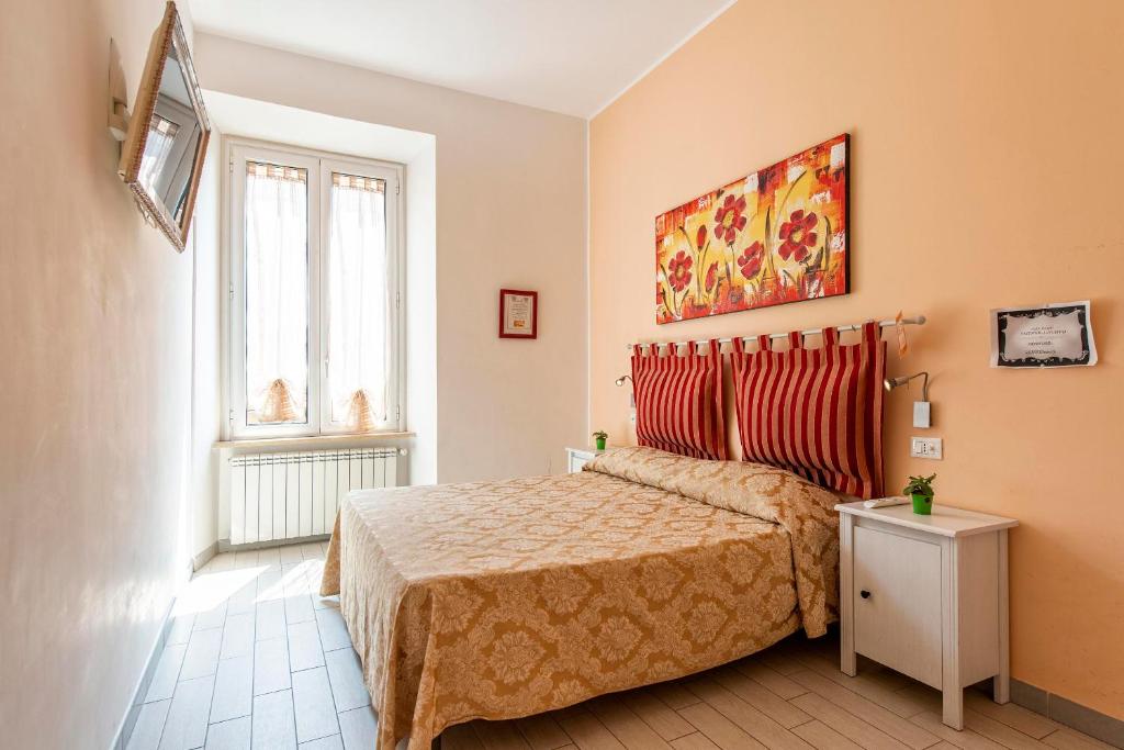 A bed or beds in a room at Merulana Suite 2