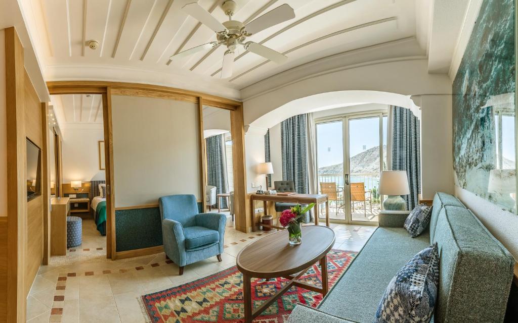 a living room with a couch and a table at Columbia Beach Resort in Pissouri