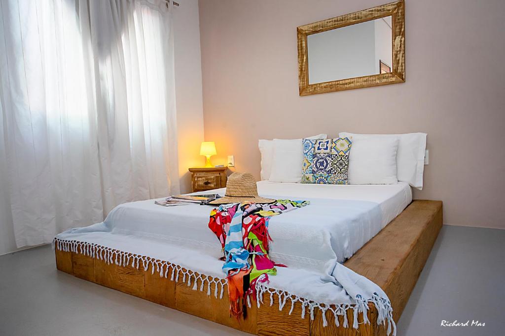 a bedroom with two beds and a mirror at Jardim Secreto in Morro de São Paulo